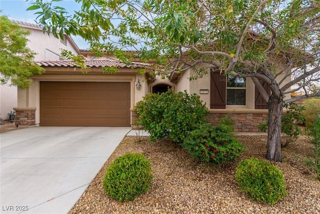 view of front of property featuring stone siding, a tile roof, concrete driveway, and stucco siding