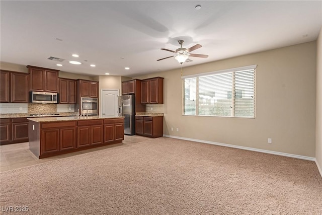 kitchen with recessed lighting, stainless steel appliances, visible vents, open floor plan, and tasteful backsplash