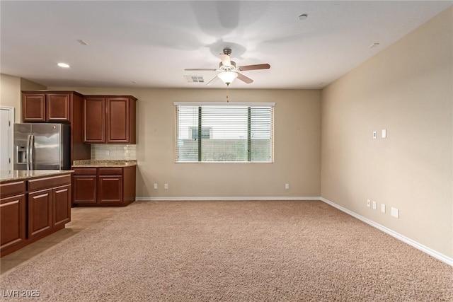 kitchen featuring baseboards, tasteful backsplash, light carpet, and stainless steel fridge with ice dispenser