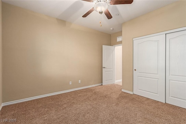 unfurnished bedroom with carpet floors, ceiling fan, baseboards, and a closet