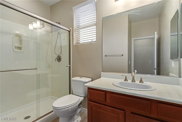 full bathroom with a stall shower, vanity, and toilet