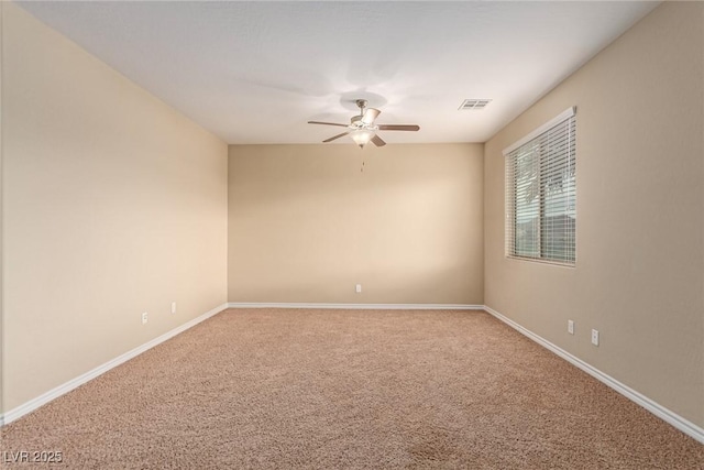 unfurnished room with carpet floors, ceiling fan, visible vents, and baseboards