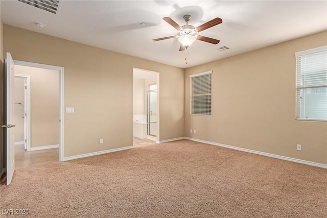 unfurnished bedroom featuring baseboards, visible vents, and light colored carpet