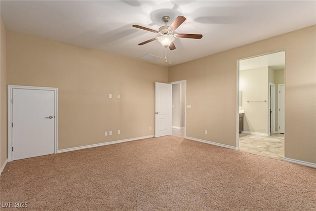 empty room featuring ceiling fan, baseboards, and light colored carpet