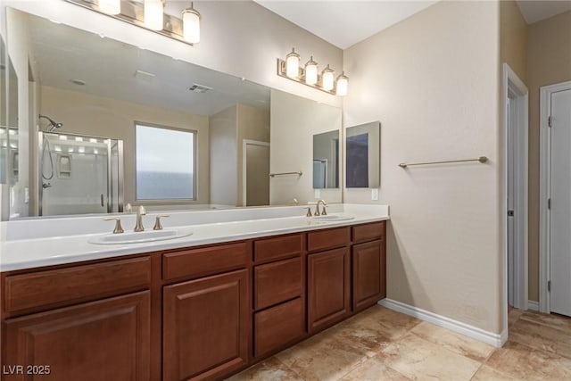 bathroom featuring visible vents, double vanity, a sink, and a shower with shower door