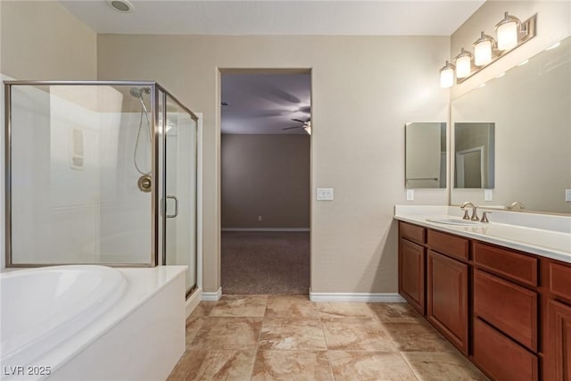 full bathroom with ceiling fan, a shower stall, vanity, baseboards, and a bath