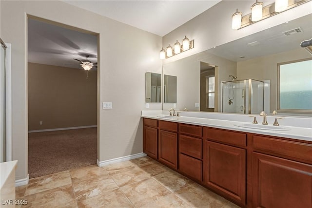 bathroom with double vanity, a stall shower, visible vents, and a sink