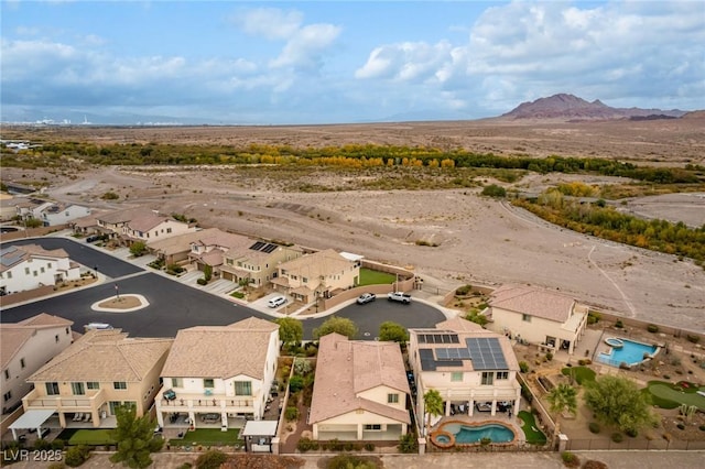 drone / aerial view featuring a residential view and a mountain view