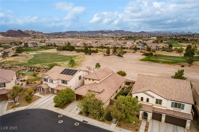 drone / aerial view with view of golf course, a residential view, and a mountain view