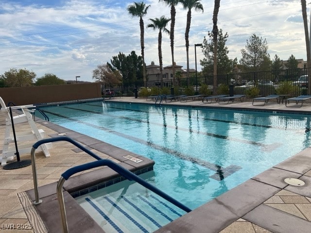 pool featuring a patio and fence