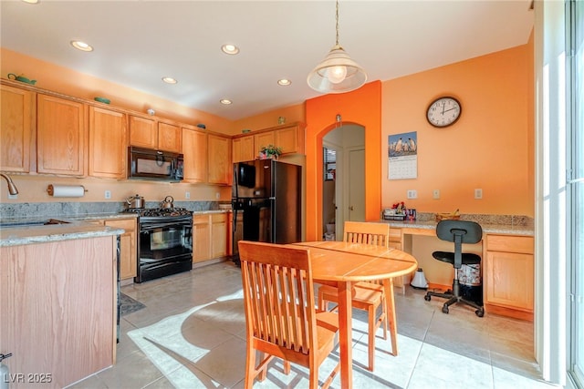 kitchen with pendant lighting, sink, light tile patterned floors, light stone counters, and black appliances