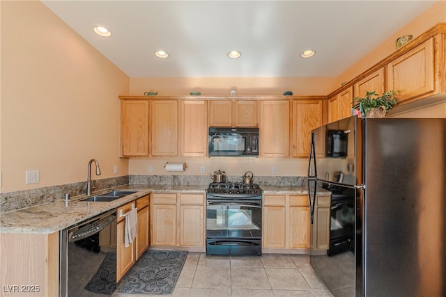 kitchen with sink, light stone counters, light tile patterned floors, light brown cabinets, and black appliances