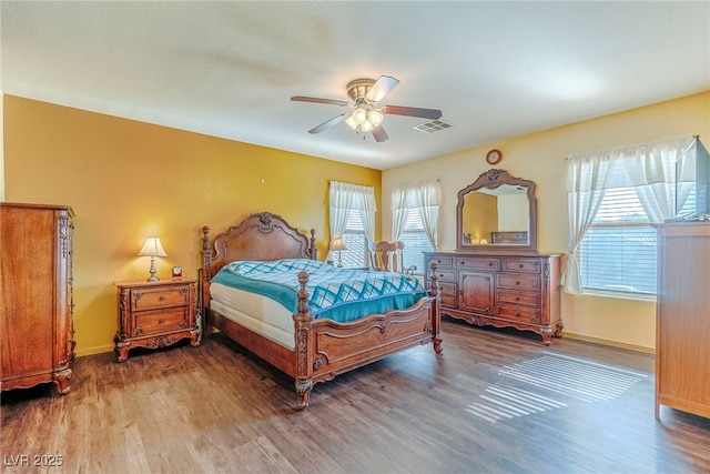 bedroom with ceiling fan and wood-type flooring