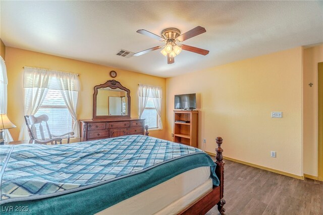 bedroom with wood-type flooring and ceiling fan