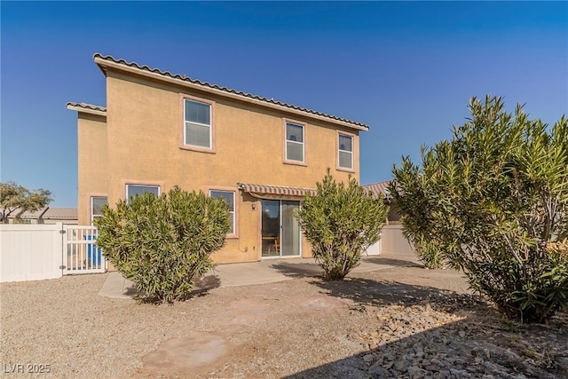 rear view of house featuring a patio