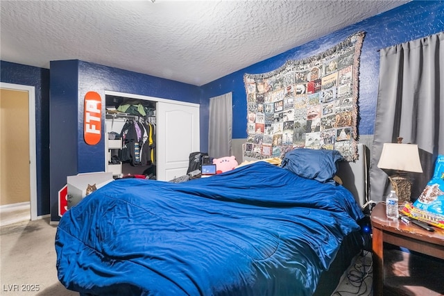 carpeted bedroom with a closet and a textured ceiling