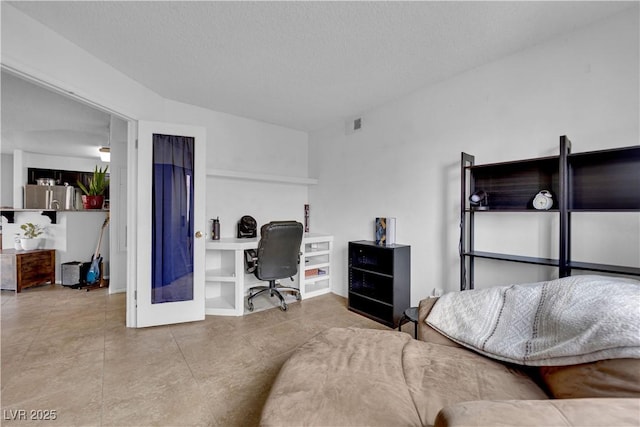 interior space featuring french doors and a textured ceiling