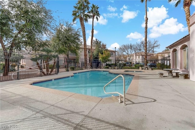 view of swimming pool with a patio area and an in ground hot tub