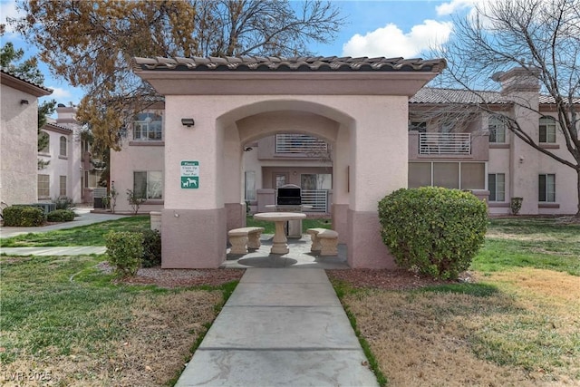 view of exterior entry with a yard