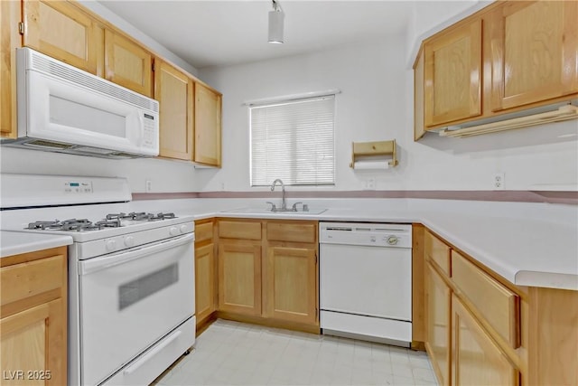 kitchen featuring white appliances, sink, and light brown cabinets