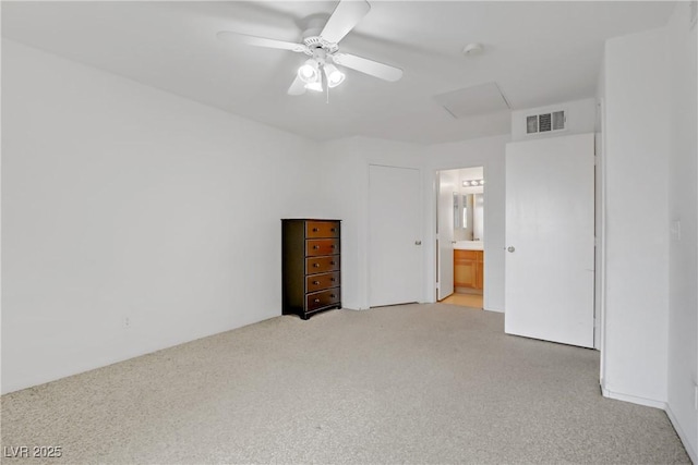 unfurnished bedroom with connected bathroom, ceiling fan, and carpet flooring