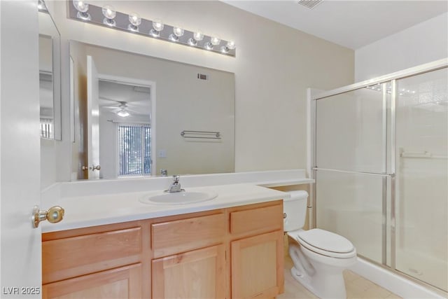 bathroom featuring vanity, toilet, tile patterned floors, and walk in shower