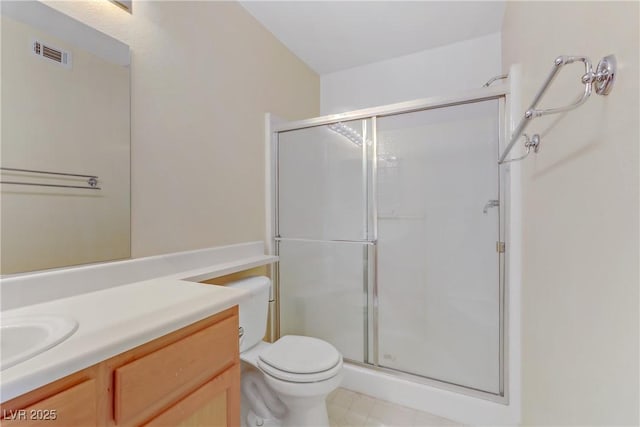 bathroom featuring walk in shower, vanity, and toilet