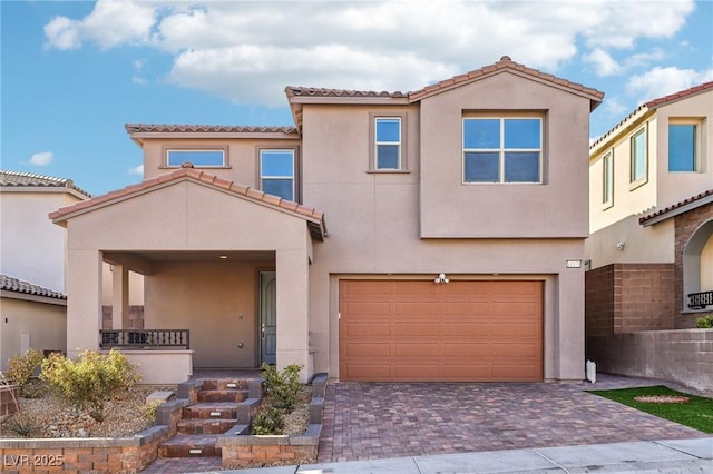 mediterranean / spanish-style house with a garage