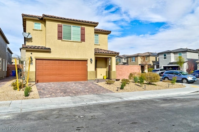 mediterranean / spanish-style home with a garage