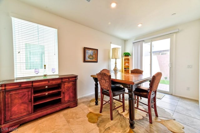 dining space featuring light tile patterned flooring