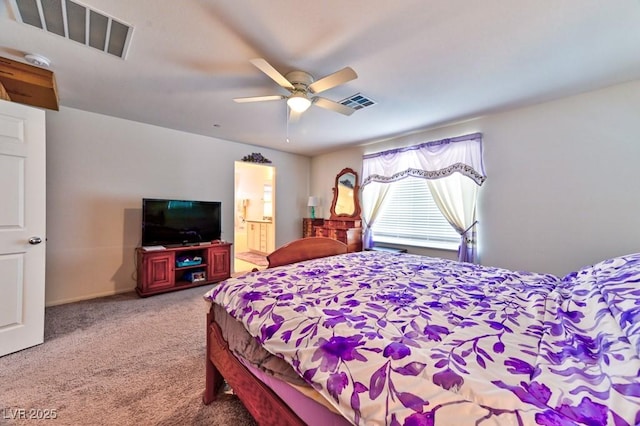 bedroom featuring ceiling fan, carpet floors, and ensuite bath