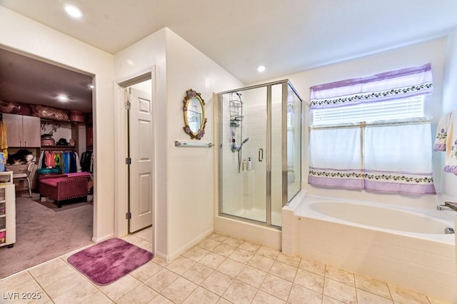 bathroom featuring plus walk in shower and tile patterned flooring