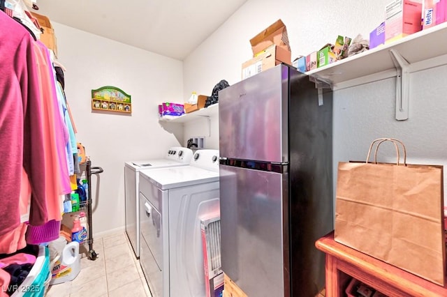 washroom with washing machine and dryer and light tile patterned flooring