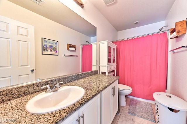 bathroom with vanity, toilet, curtained shower, and tile patterned flooring