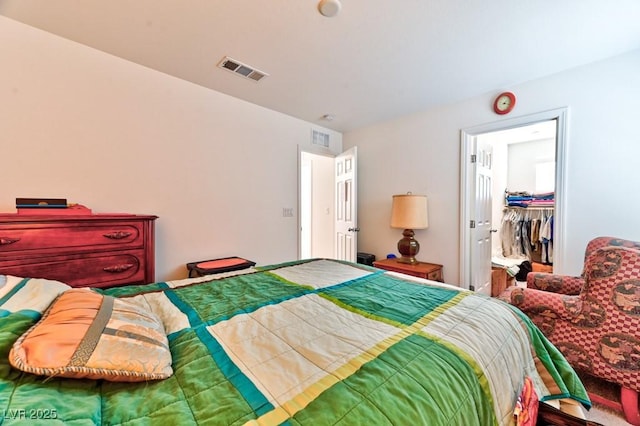 bedroom featuring a walk in closet