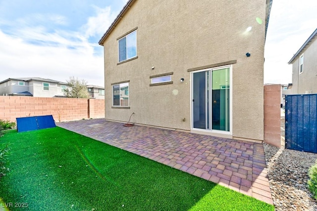 back of house with a patio and a yard