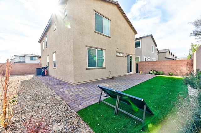 rear view of house with a yard, central AC unit, and a patio