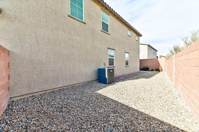 rear view of house featuring a patio and cooling unit