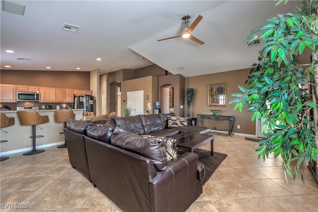 tiled living room featuring lofted ceiling and ceiling fan