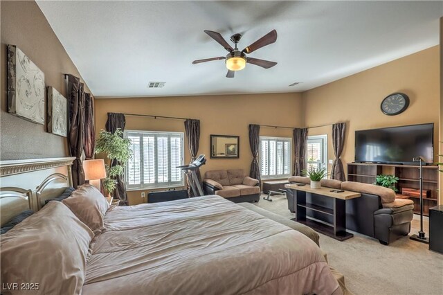 carpeted bedroom with multiple windows, vaulted ceiling, and ceiling fan