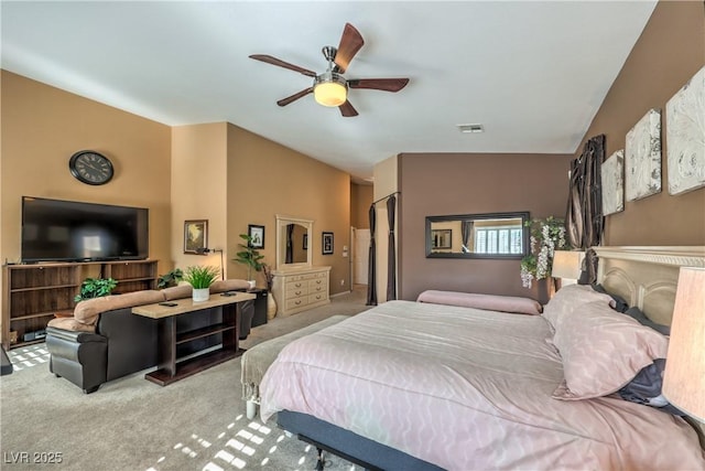 carpeted bedroom featuring lofted ceiling and ceiling fan