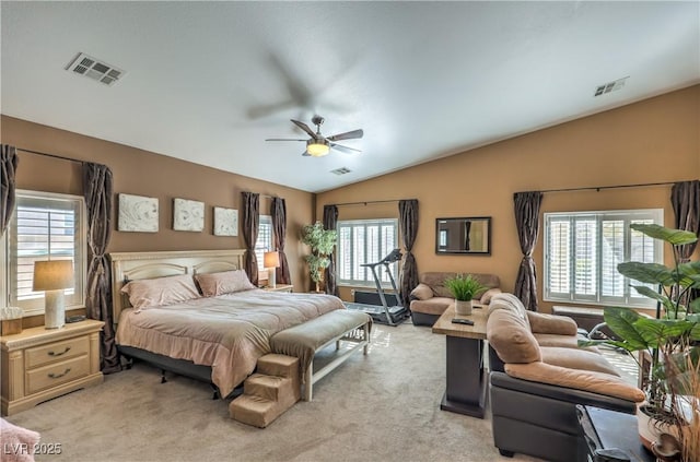 bedroom with lofted ceiling, light colored carpet, and ceiling fan