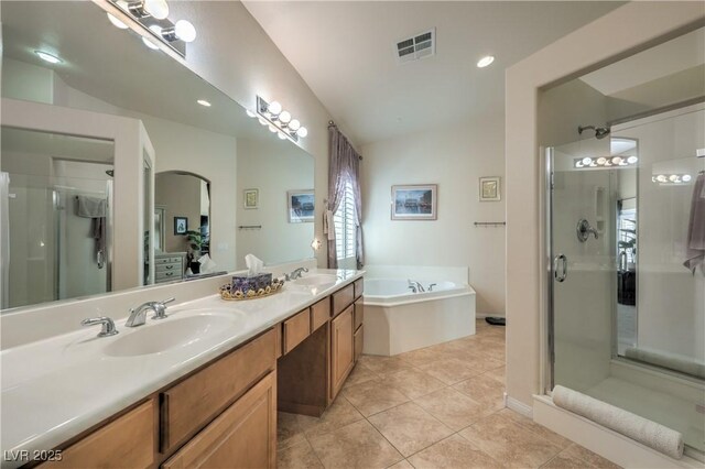 bathroom featuring tile patterned floors, shower with separate bathtub, vaulted ceiling, and vanity