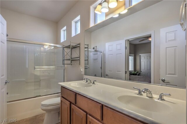 full bathroom featuring vanity, tile patterned flooring, enclosed tub / shower combo, and toilet