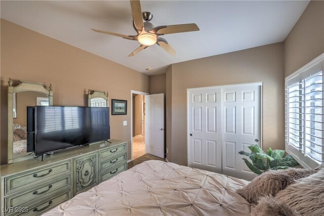 bedroom featuring ceiling fan and a closet