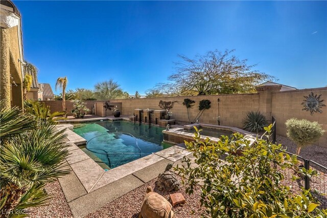 view of swimming pool featuring an in ground hot tub