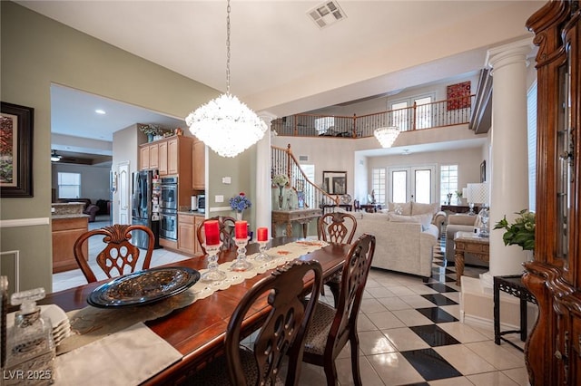 dining room featuring ceiling fan with notable chandelier and decorative columns