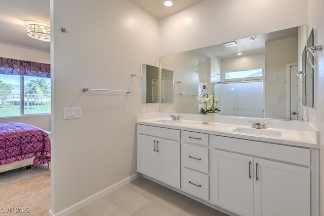 bathroom featuring a shower with door, vanity, and tile patterned flooring