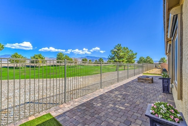 view of patio featuring a mountain view and a fire pit