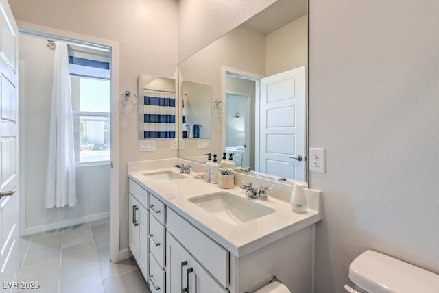 bathroom featuring tile patterned flooring, vanity, and toilet